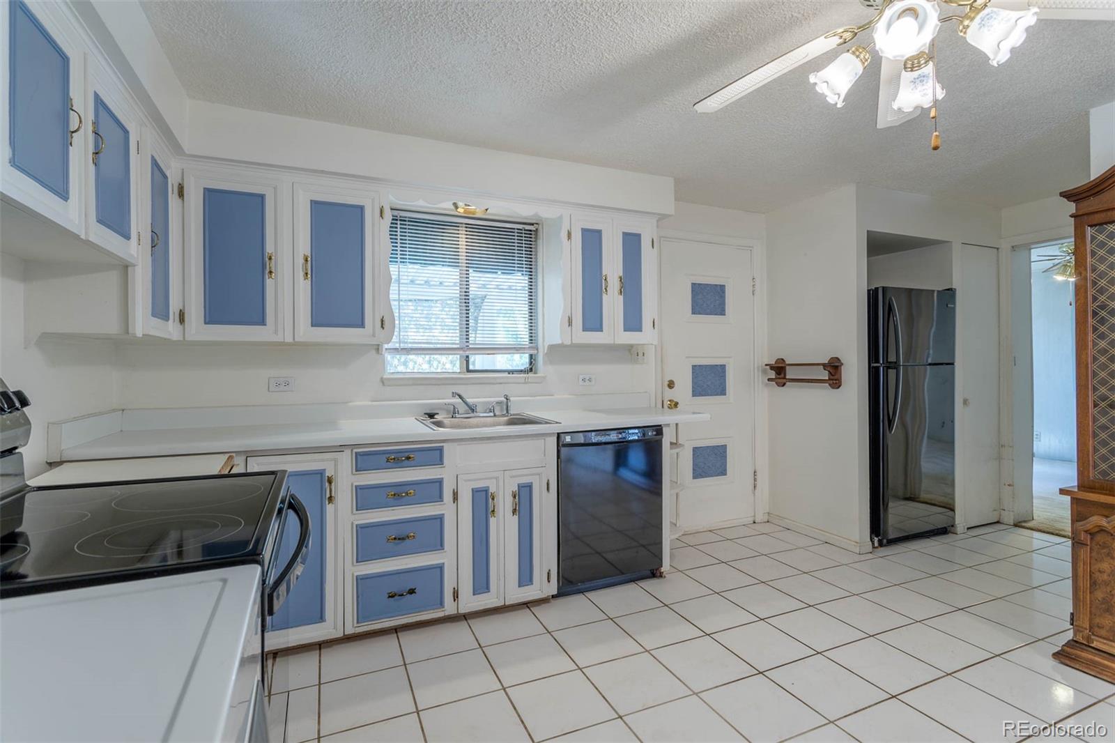 3075 South Emerson Way Englewood, CO 80113 - Photo 8 of 28 a kitchen with a sink cabinets and stainless steel appliances