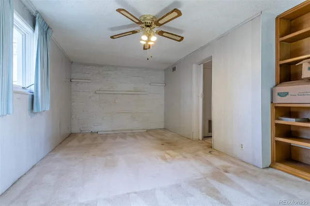 an empty room with closet and a window