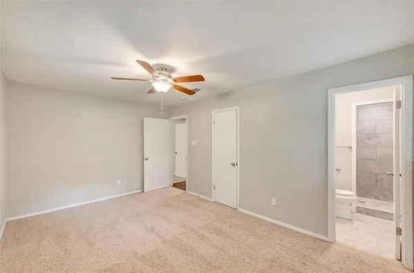 a view of an empty room and a ceiling fan