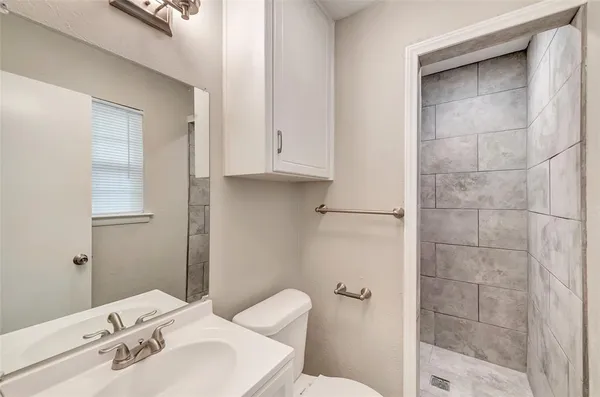 a bathroom with a sink toilet and shower