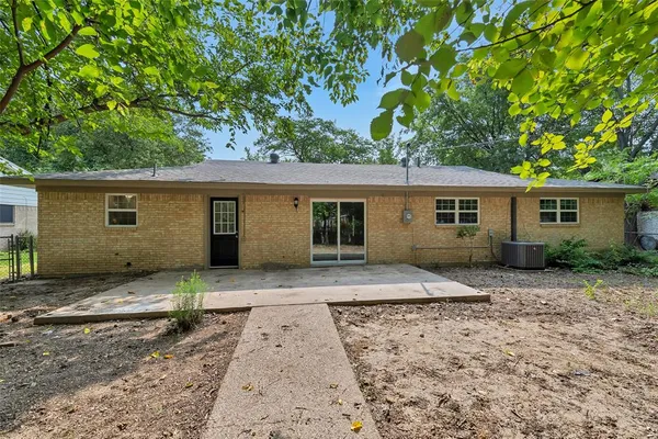 front view of a house with a tree in front of it