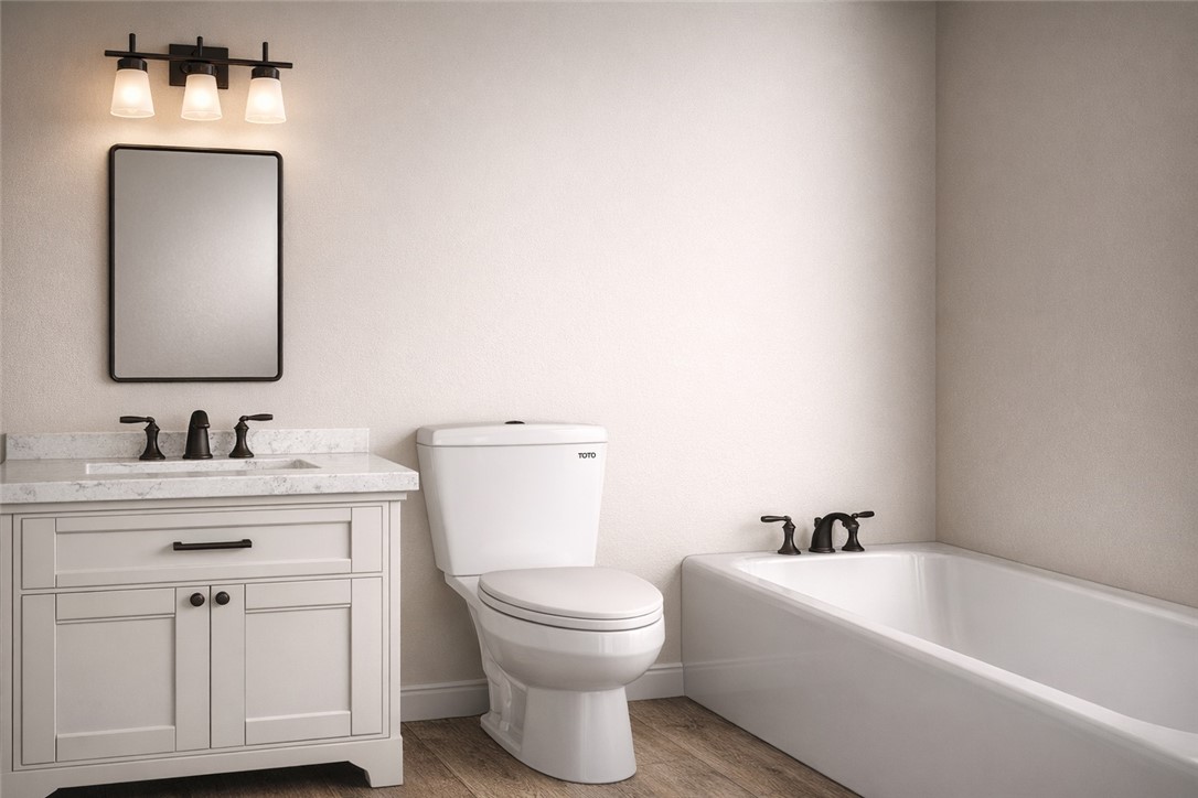 2572 Shady Rte Lane Bryan, TX 77803 - Photo 11 of 17 a bathroom with a toilet a sink a mirror and bathtub