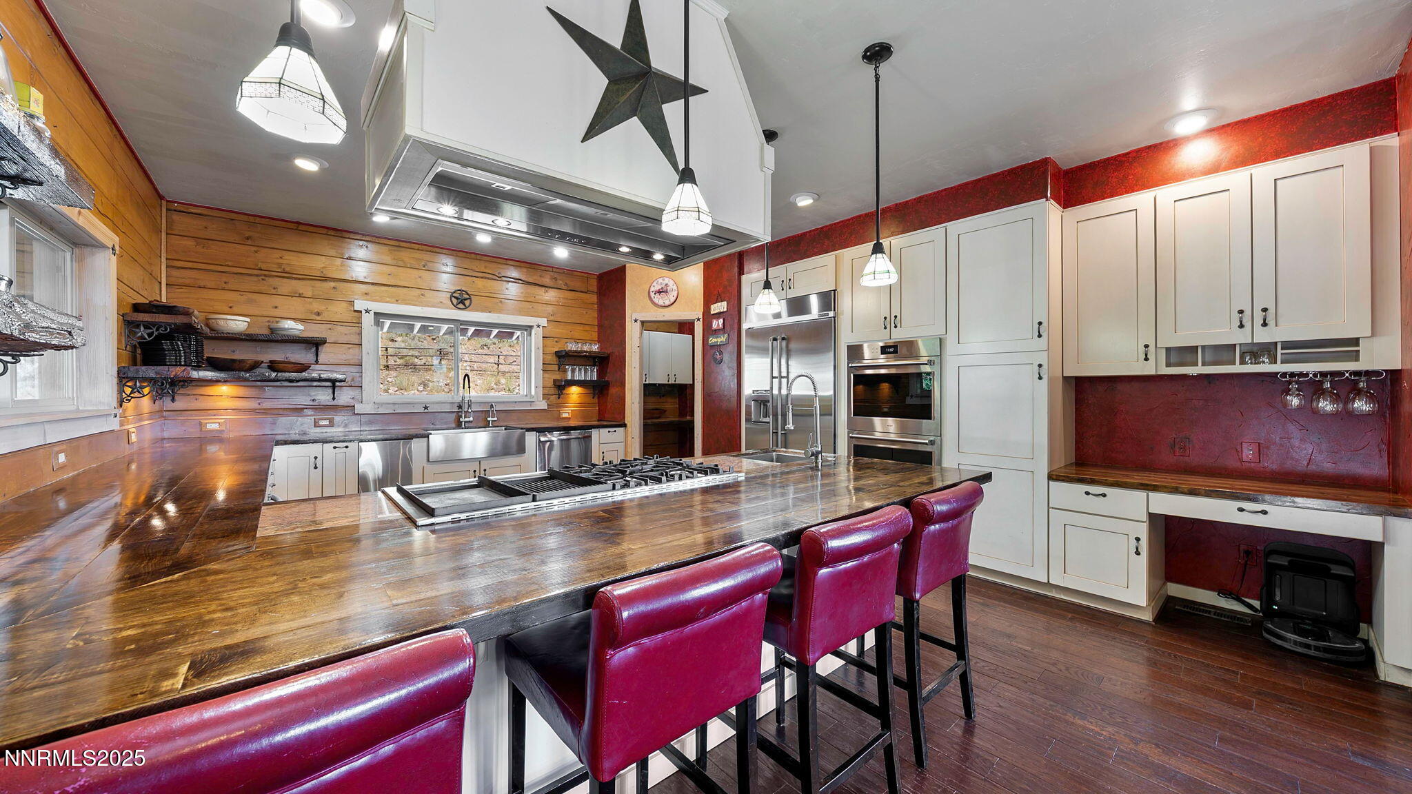 16700 Mt Rose Highway Reno, NV 89511 - Photo 21 of 50 a room with stainless steel appliances kitchen island granite countertop a table chairs and a wooden floor