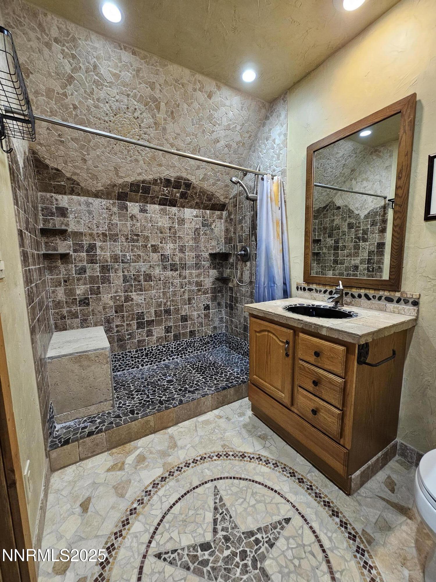 16700 Mt Rose Highway Reno, NV 89511 - Photo 33 of 50 a bathroom with a sink a vanity and a mirror