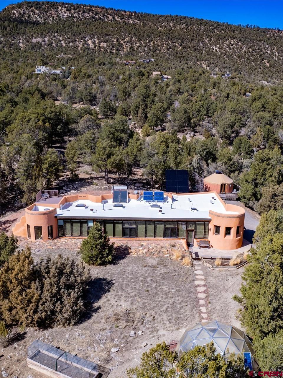 1137 Pleasant Point Drive Ridgway, CO 81432 - Photo 2 of 34 an aerial view of a house with yard and mountain view in back