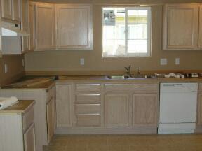 10050 South Naches Road Naches, WA 98937 - Photo 4 of 4 a kitchen with granite countertop white cabinets and a sink