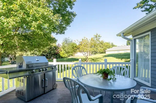 a view of a balcony with a table and chairs