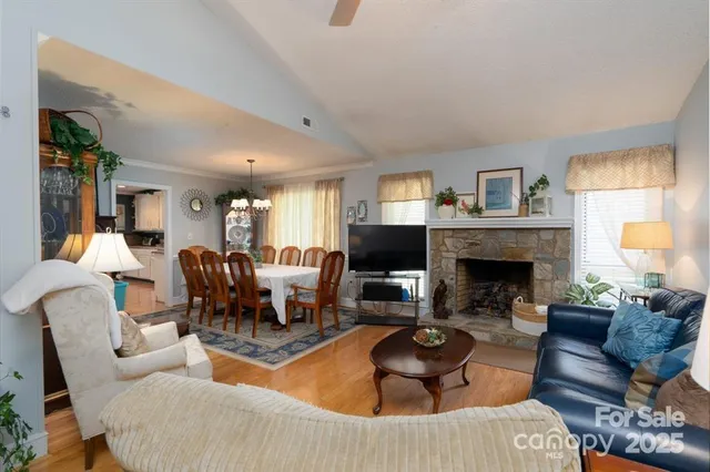a living room with furniture fireplace and window