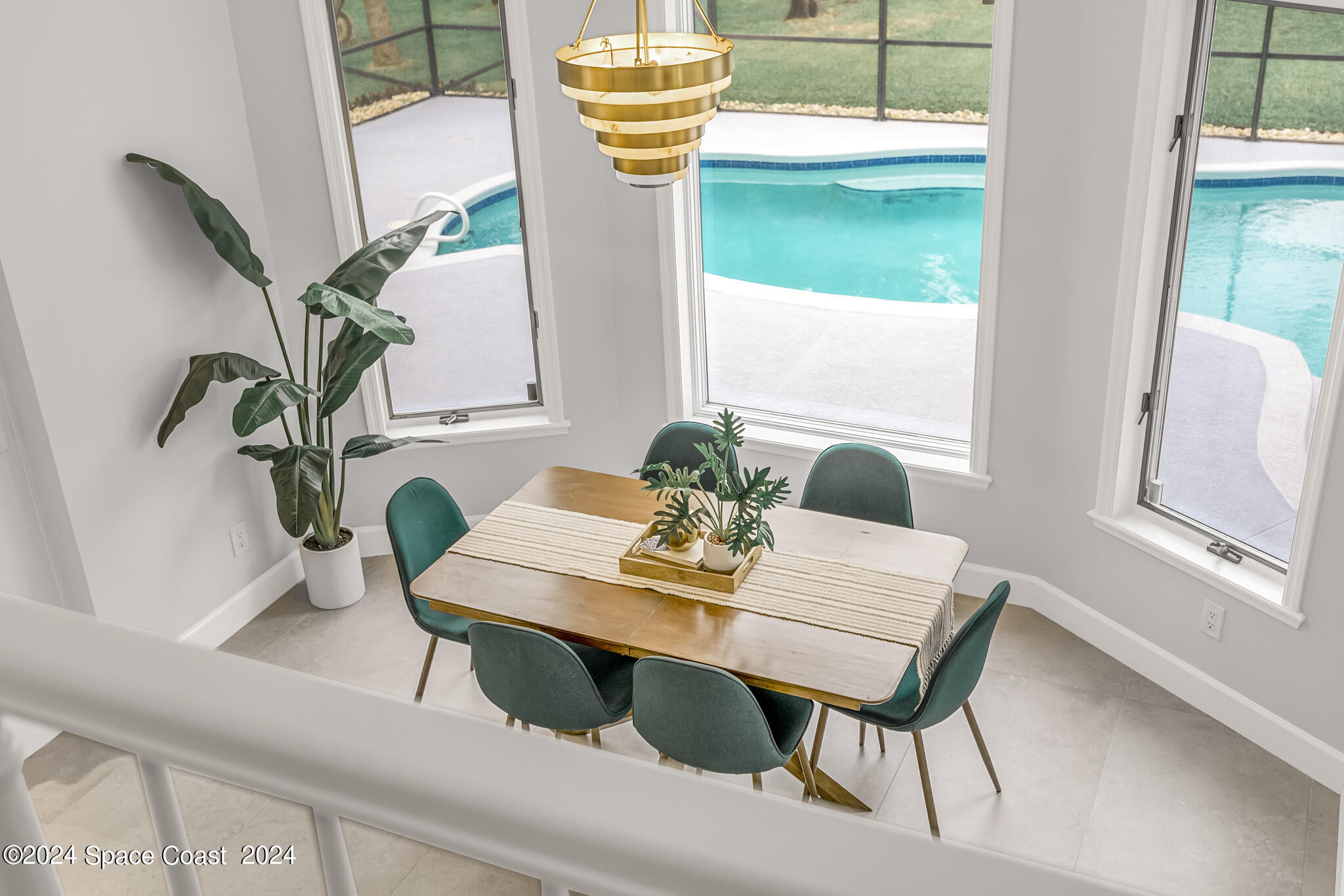 3671 Big Pine Road Melbourne, FL 32934 - Photo 14 of 60 a view of a dining room with furniture and a potted plant