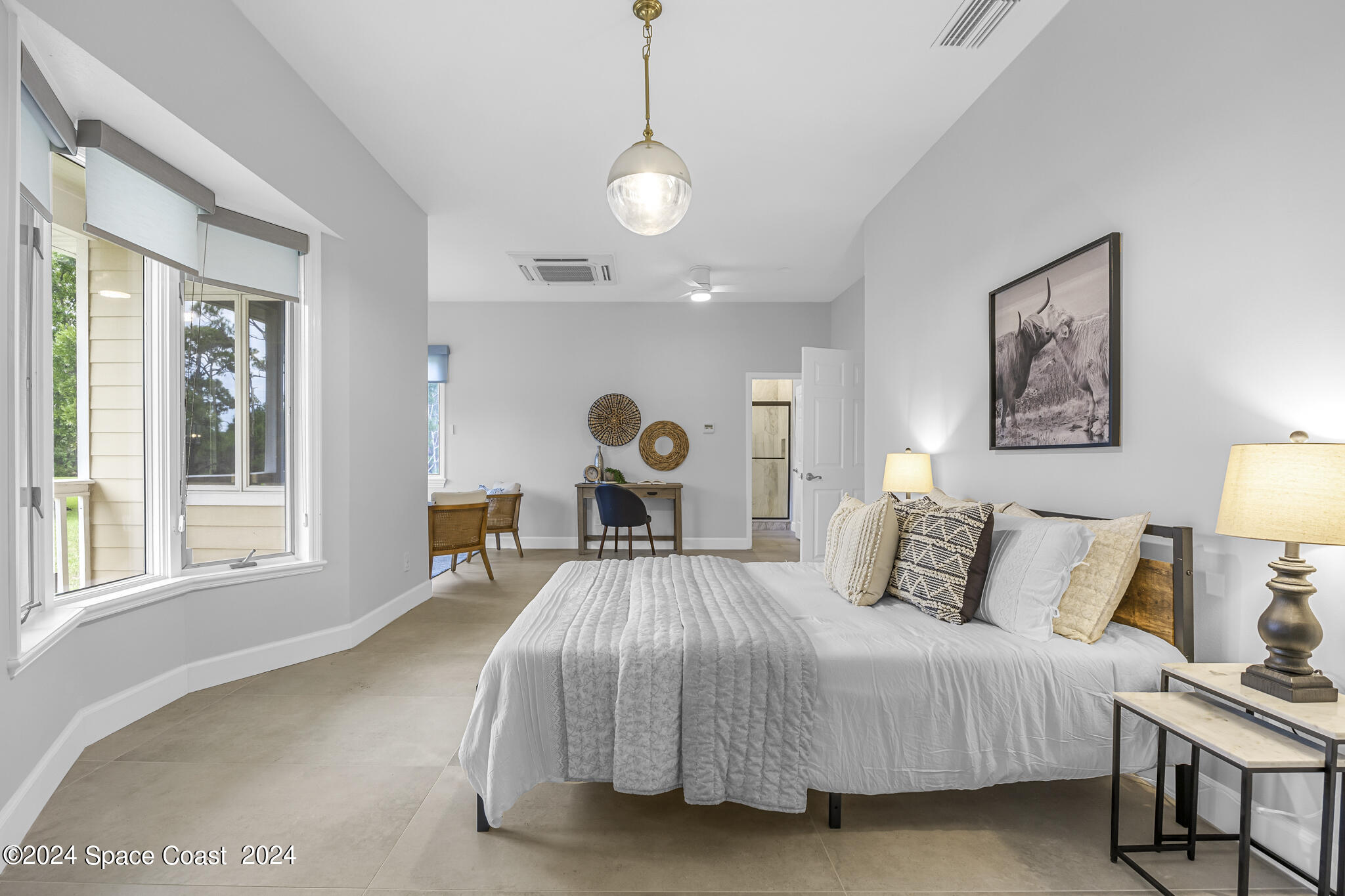 3671 Big Pine Road Melbourne, FL 32934 - Photo 23 of 60 a bedroom with a bed and a large window