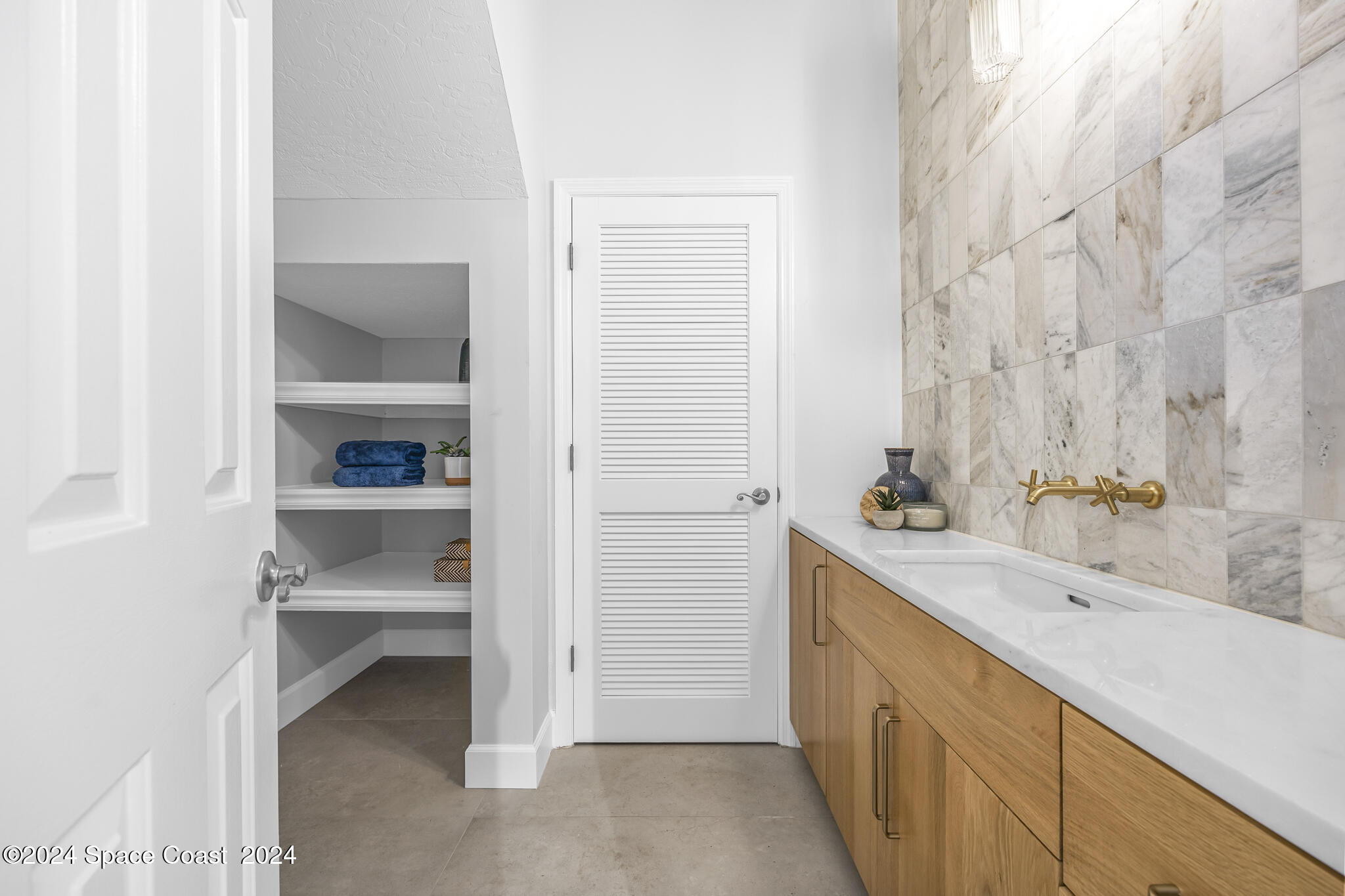 3671 Big Pine Road Melbourne, FL 32934 - Photo 28 of 60 a bathroom with a double vanity sink a toilet and a bathtub