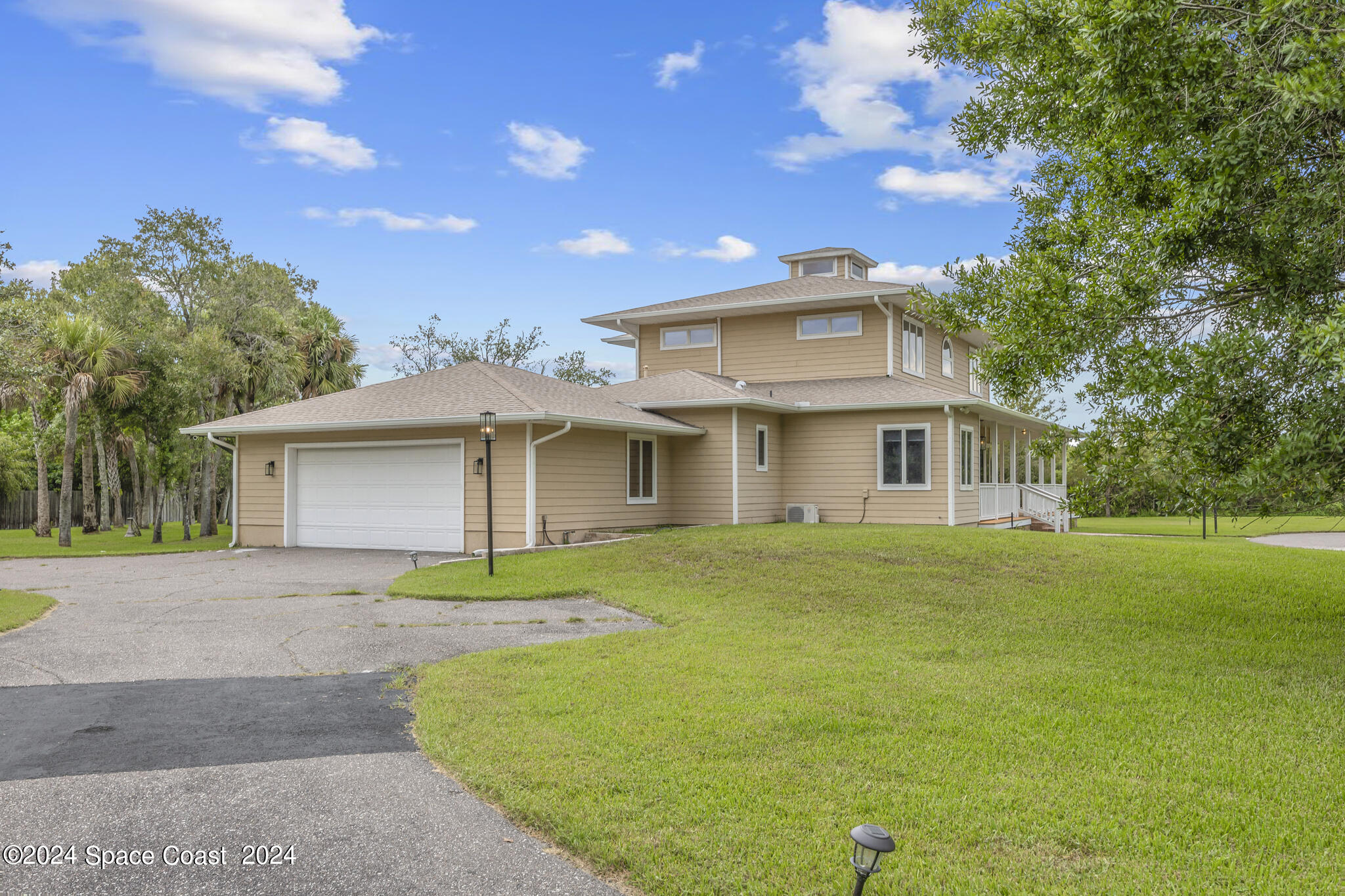 3671 Big Pine Road Melbourne, FL 32934 - Photo 3 of 60 a front view of a house with a garden