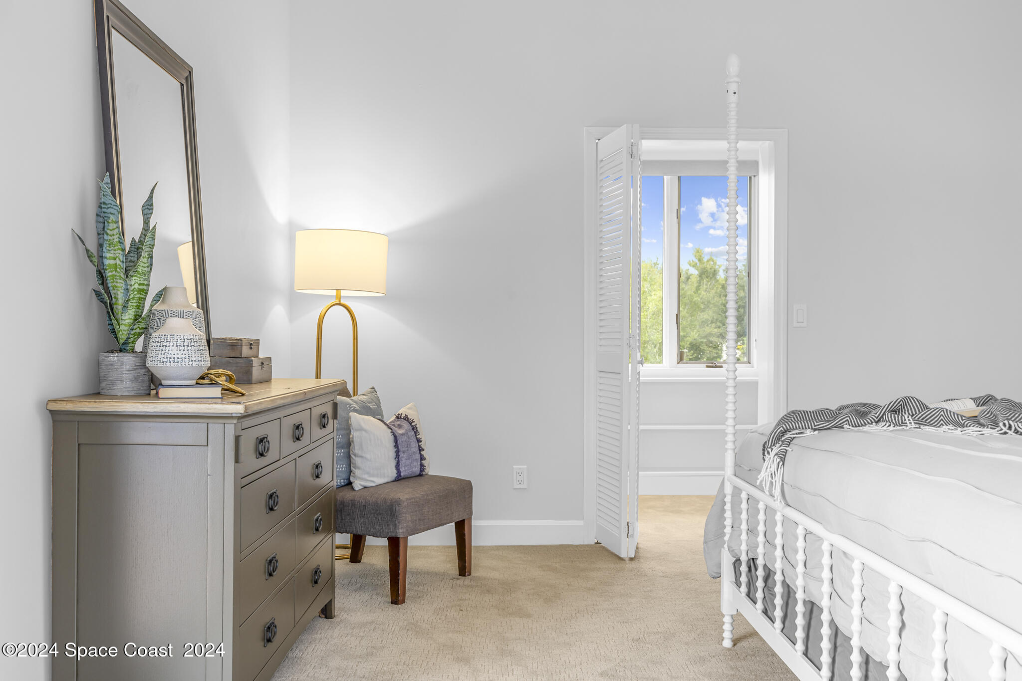 3671 Big Pine Road Melbourne, FL 32934 - Photo 32 of 60 a bedroom with a bed and a potted plant