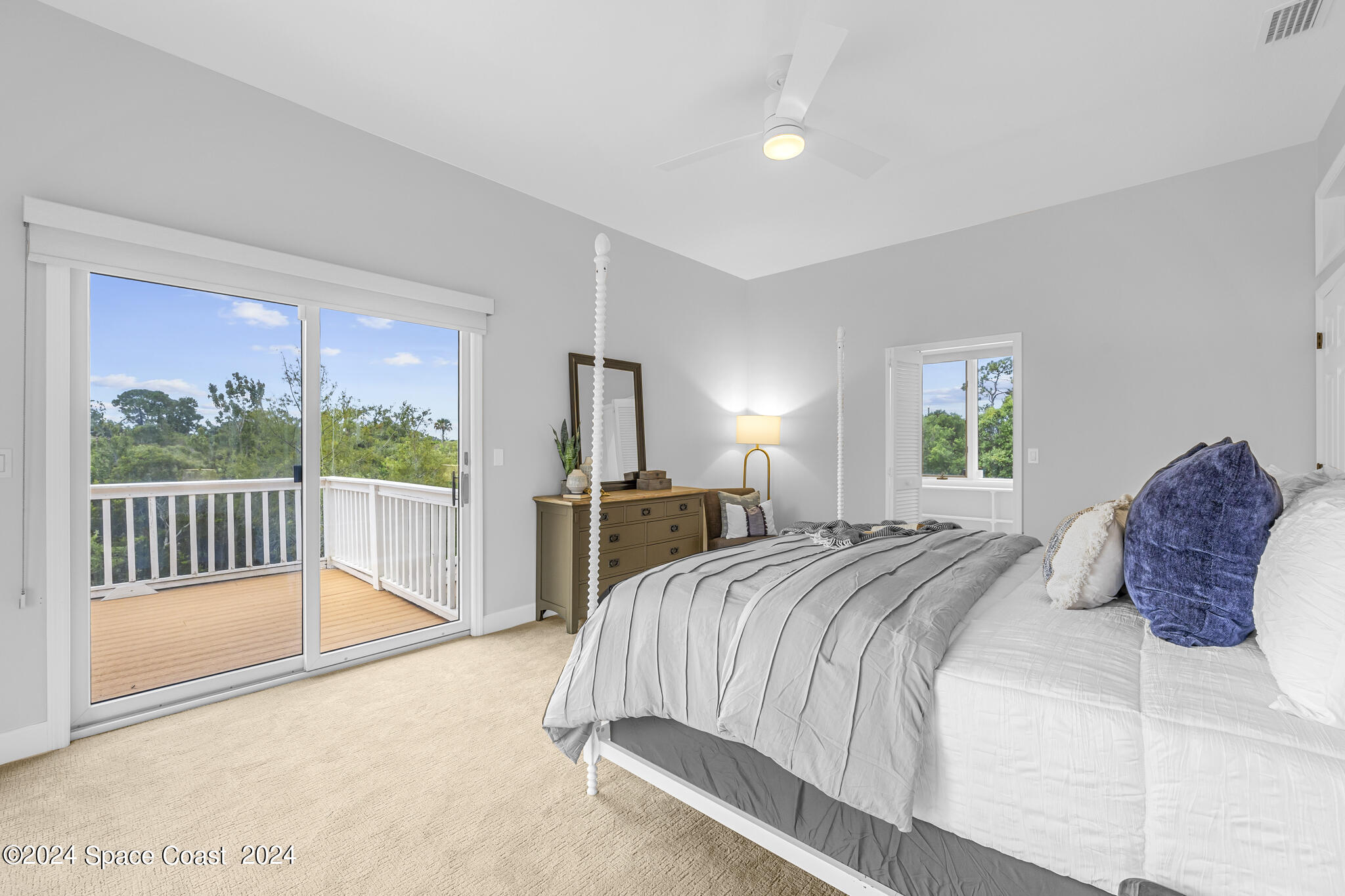 3671 Big Pine Road Melbourne, FL 32934 - Photo 33 of 60 a bedroom with a large bed and a large window
