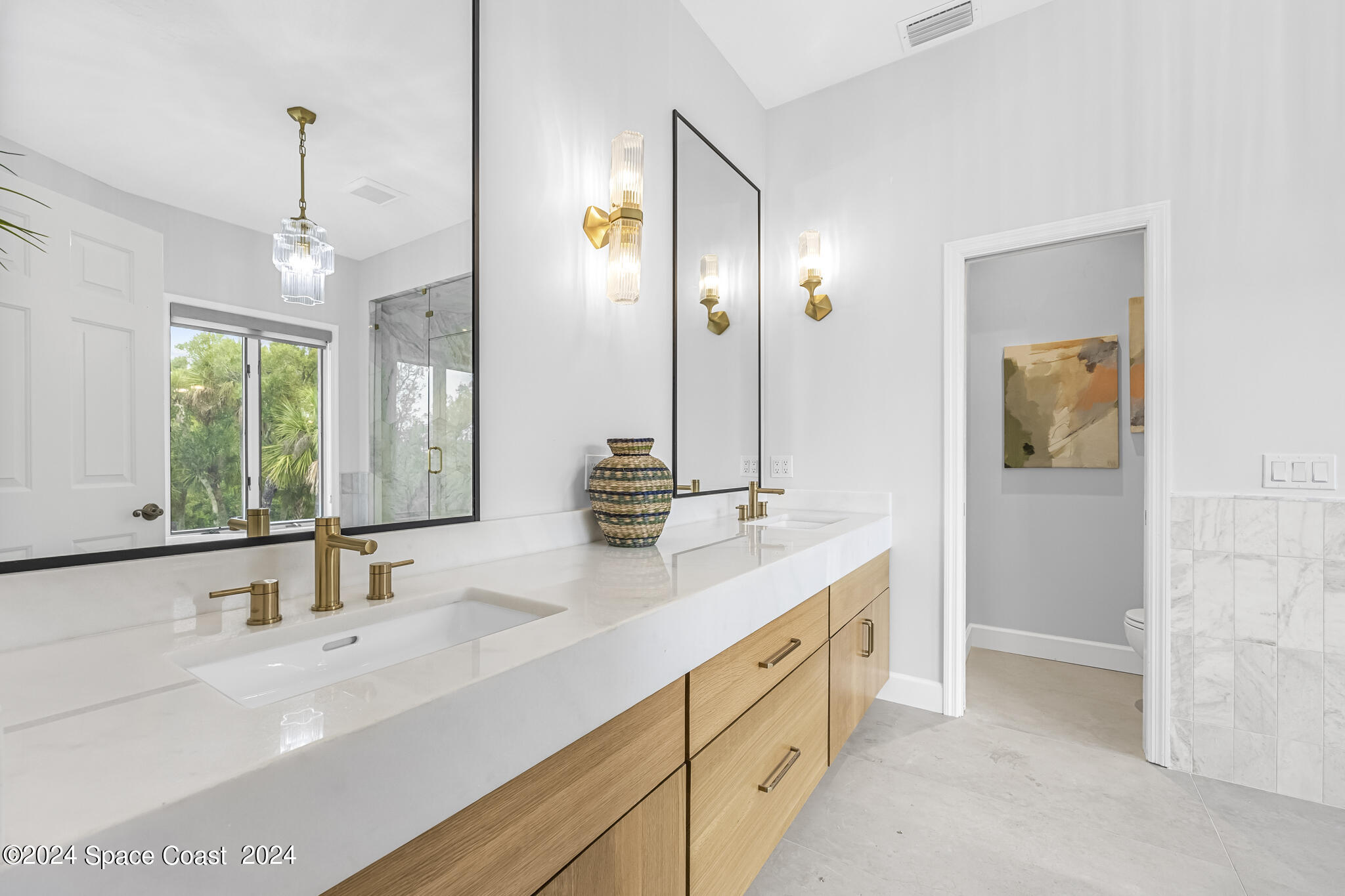 3671 Big Pine Road Melbourne, FL 32934 - Photo 35 of 60 a bathroom with a double vanity sink mirror and double
