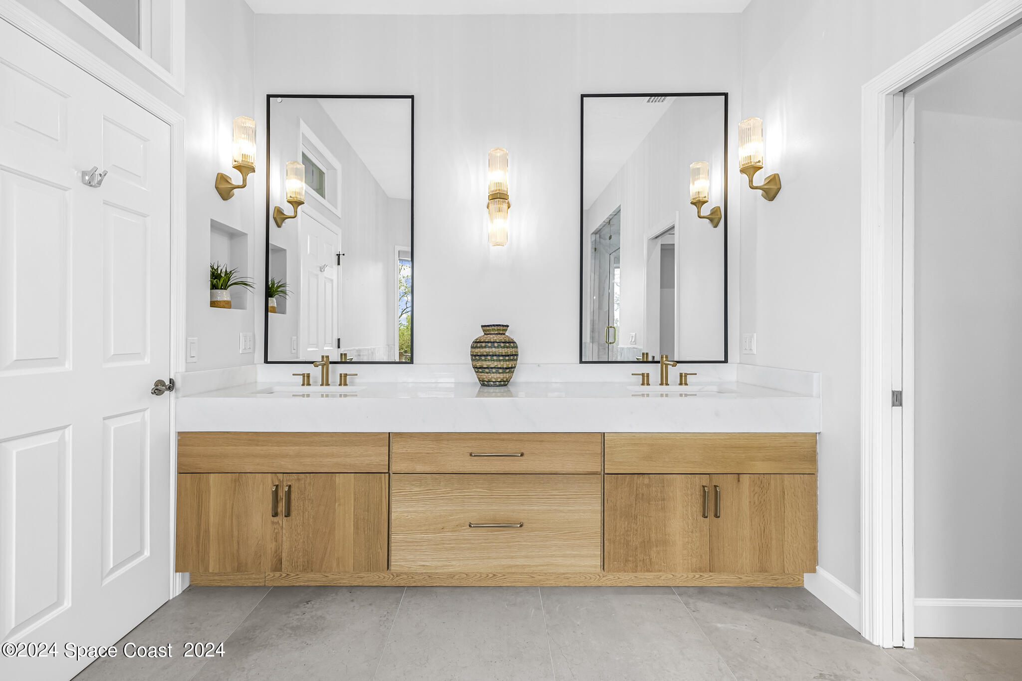 3671 Big Pine Road Melbourne, FL 32934 - Photo 36 of 60 a bathroom with a double vanity sink mirror and bathtub