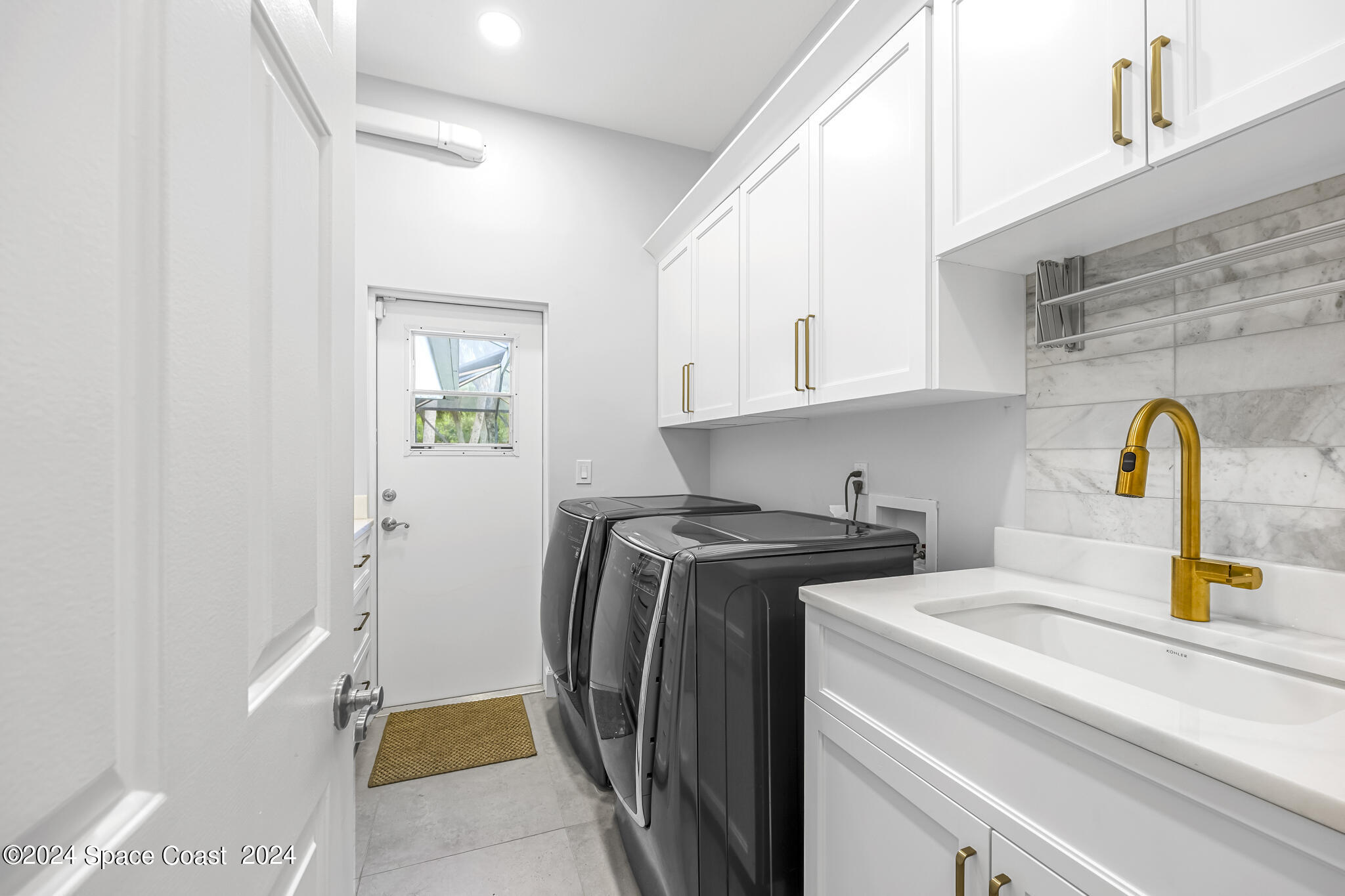 3671 Big Pine Road Melbourne, FL 32934 - Photo 48 of 60 a utility room with dryer and washer