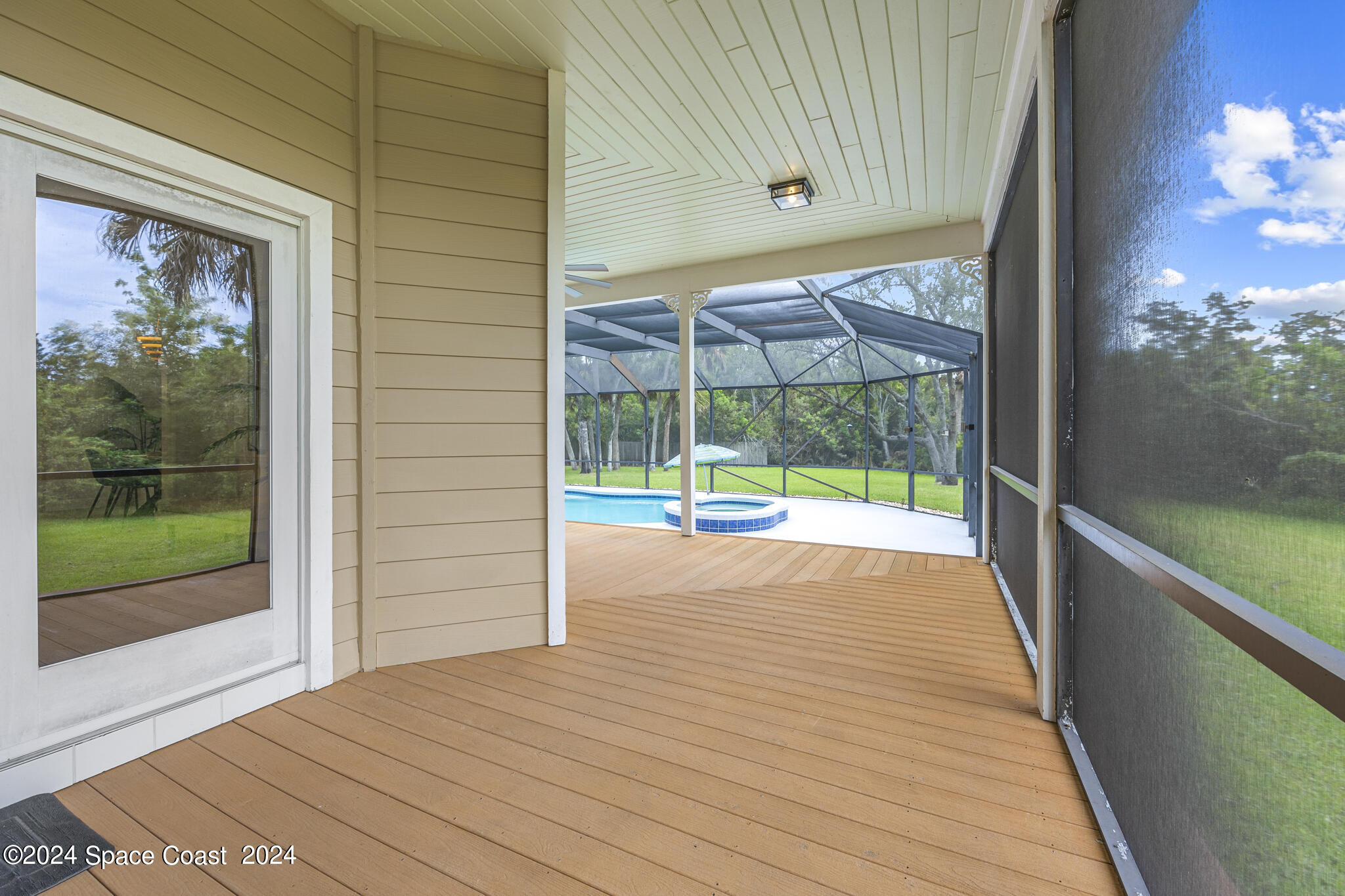 3671 Big Pine Road Melbourne, FL 32934 - Photo 49 of 60 a view of porch with a floor to ceiling window next to a yard