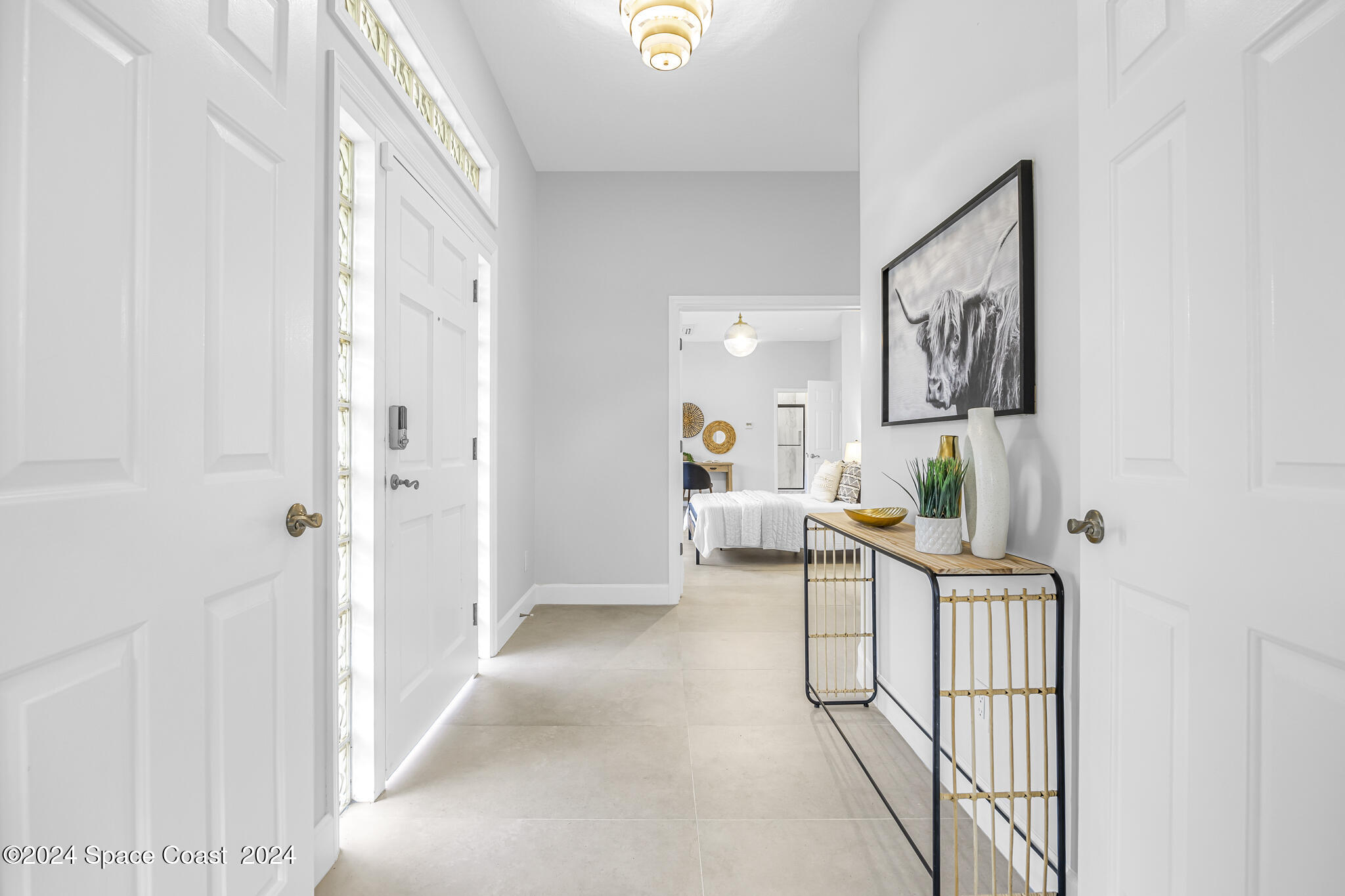 3671 Big Pine Road Melbourne, FL 32934 - Photo 5 of 60 a view of a hallway to a livingroom with furniture and windows