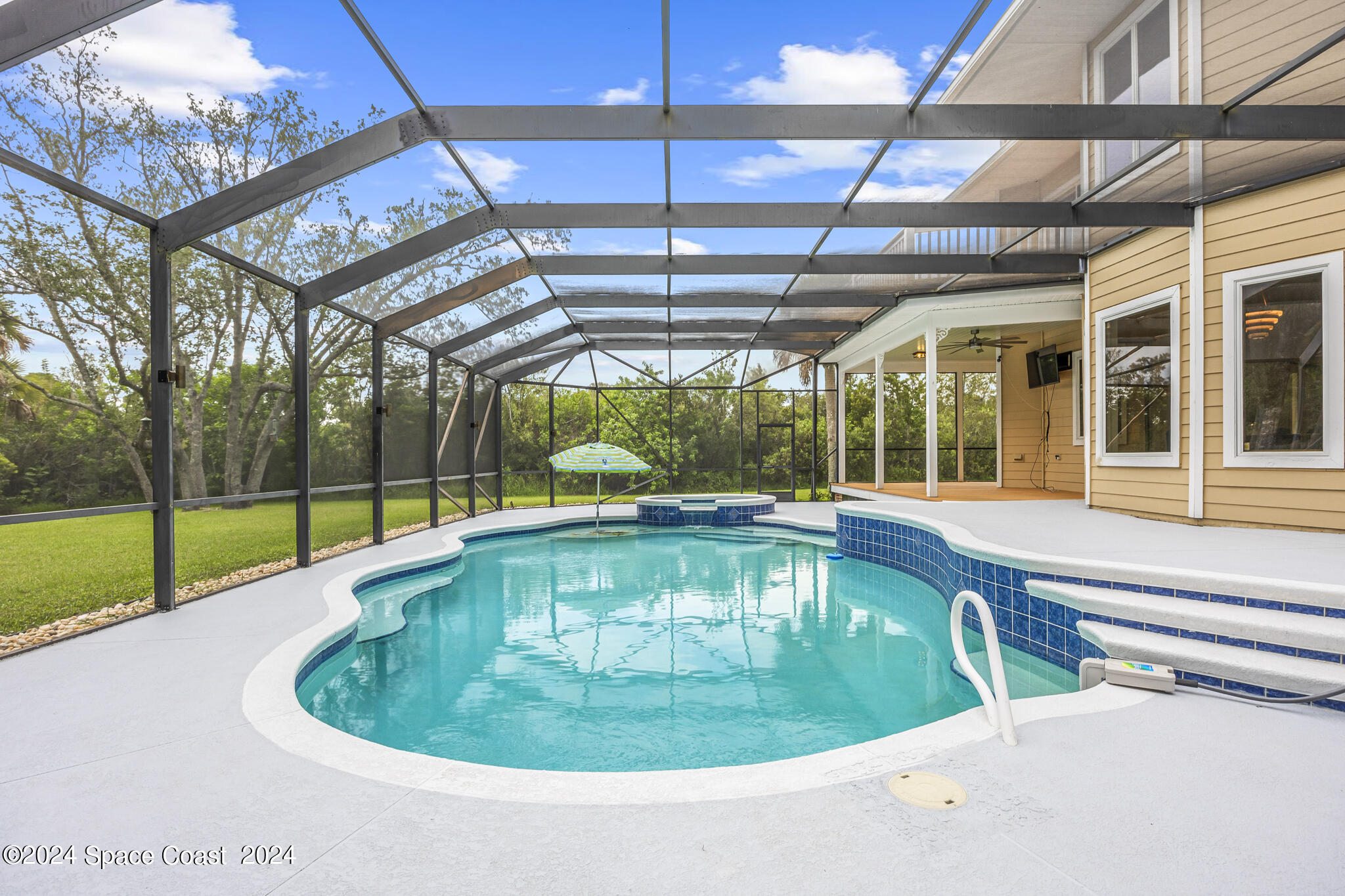 3671 Big Pine Road Melbourne, FL 32934 - Photo 52 of 60 a view of a swimming pool with a yard