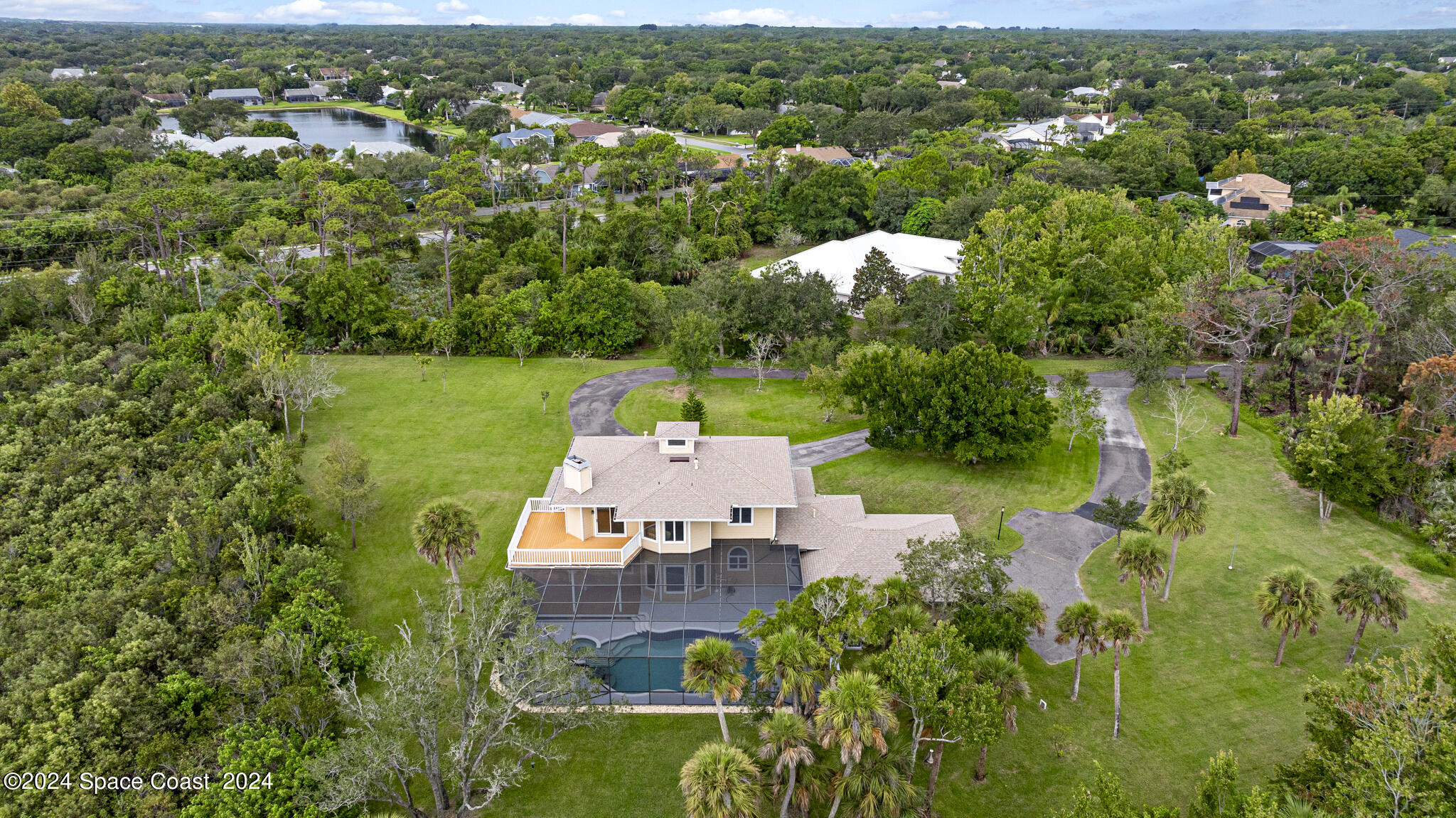 3671 Big Pine Road Melbourne, FL 32934 - Photo 58 of 60 an aerial view of a house with a yard and lake view