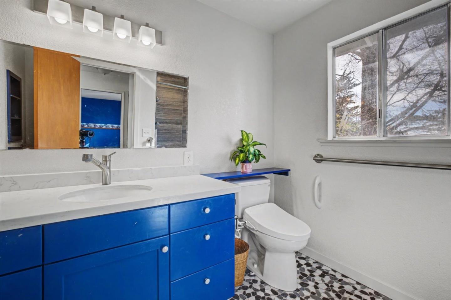 416 Spring Street Santa Cruz, CA 95060 - Photo 18 of 28 a bathroom with a toilet sink and mirror
