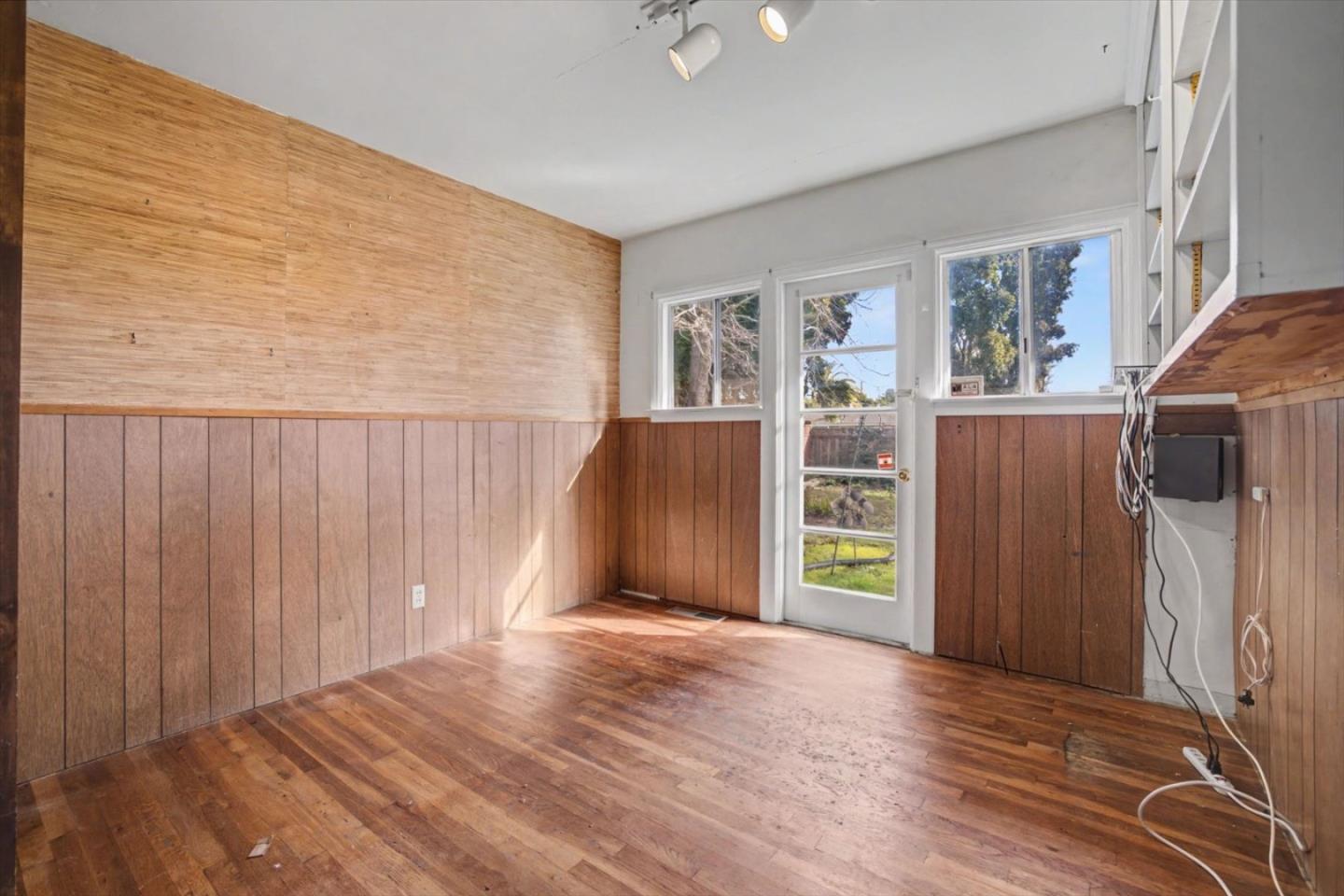 416 Spring Street Santa Cruz, CA 95060 - Photo 19 of 28 a view of an empty room with wooden floor and a window