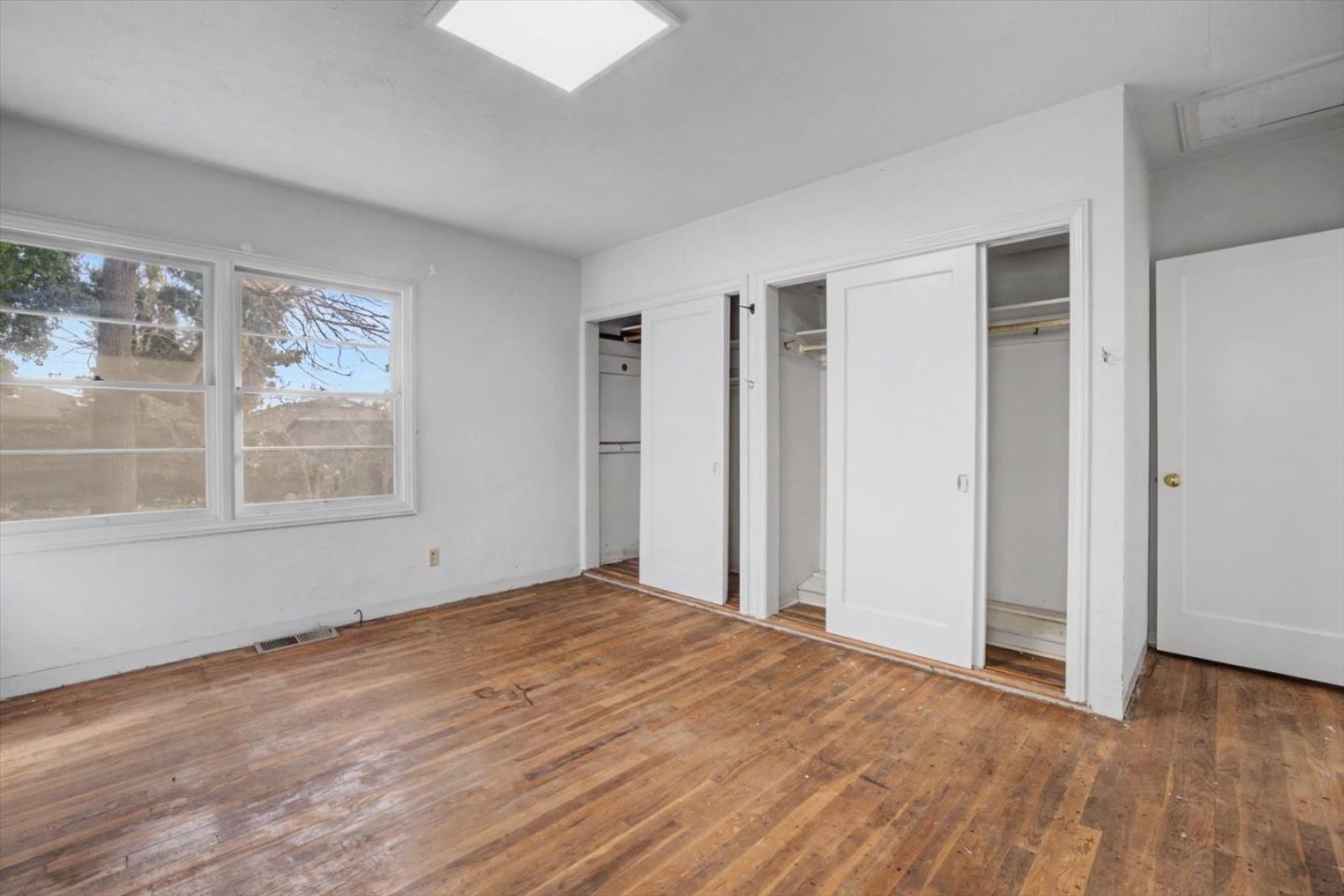 416 Spring Street Santa Cruz, CA 95060 - Photo 20 of 28 a view of an empty room with wooden floor and a window