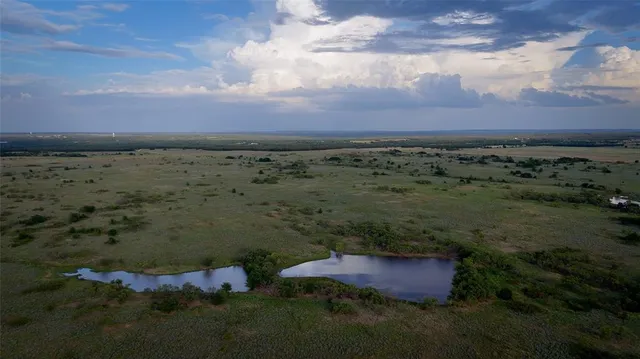 a view of a lake with houses in the back