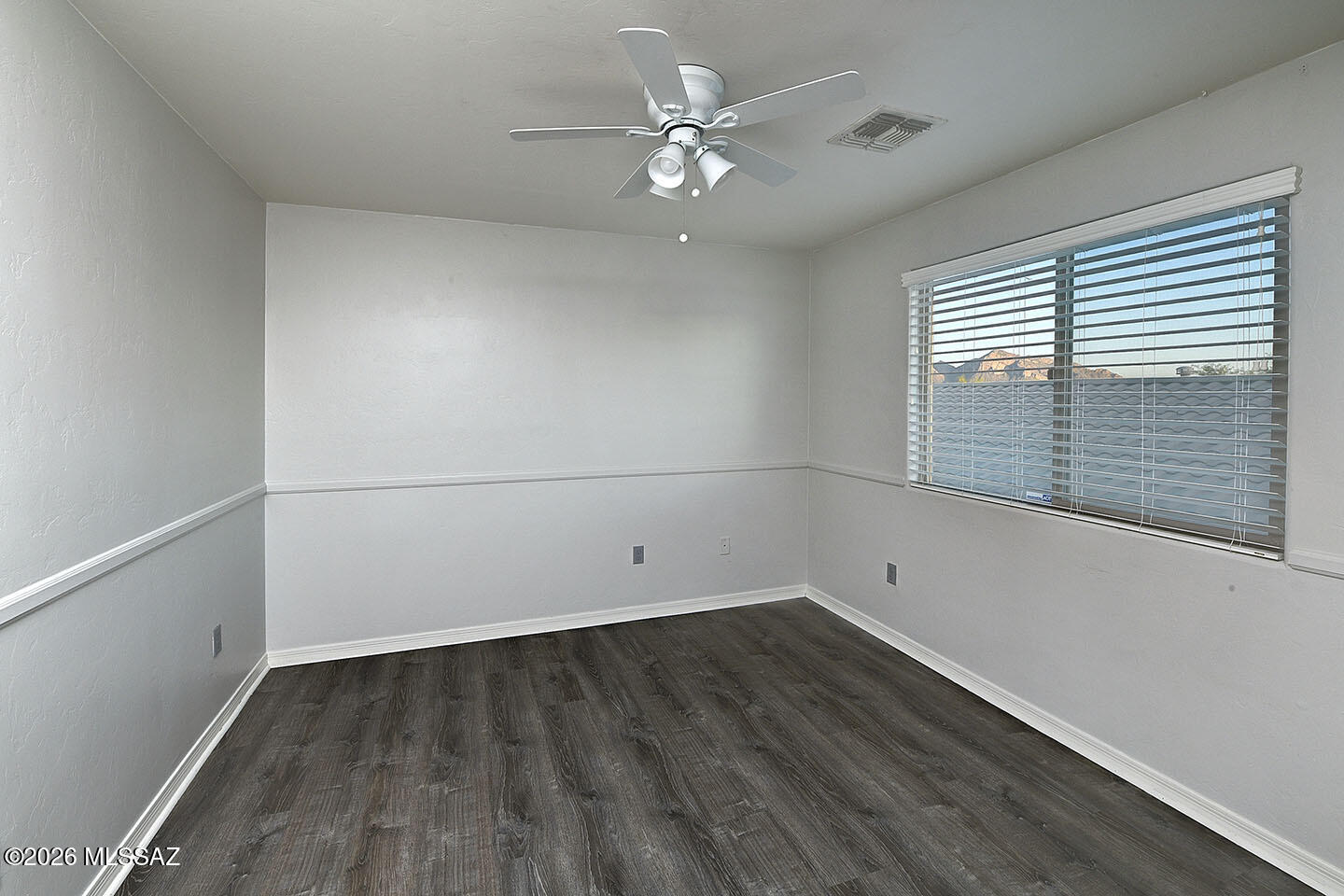 13464 North Piemonte Way Oro Valley, AZ 85755 - Photo 22 of 33 wooden floor in an empty room with a window