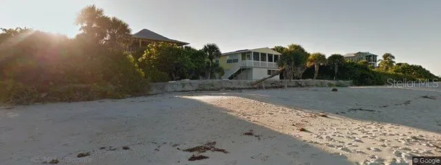a view of a dirt road and a building