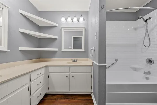 a bathroom with a sink a mirror and a bathtub