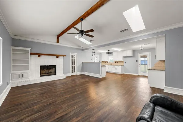 a view of a room with wooden floor and a fireplace