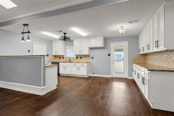 a kitchen with stainless steel appliances a refrigerator sink and cabinets