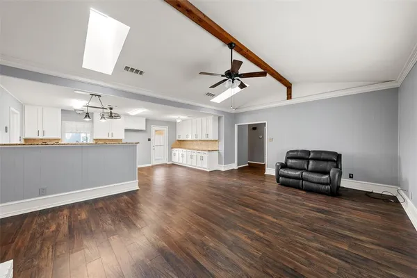 a kitchen with kitchen island white cabinets and stainless steel appliances