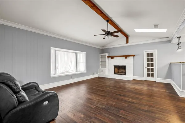 a view of livingroom with furniture fireplace and wooden floor