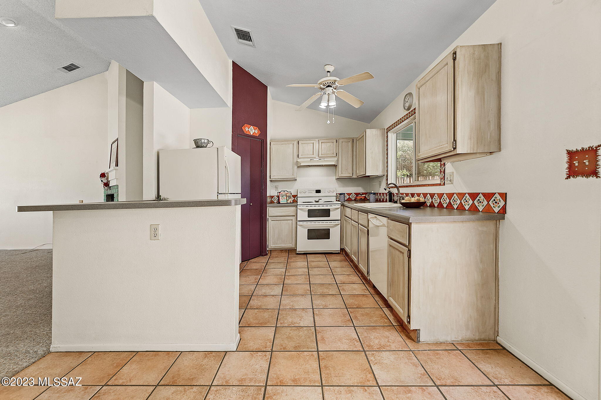 10610 Keystone Road East Tucson, AZ 85730 - Photo 11 of 35 a kitchen with stainless steel appliances granite countertop a stove a sink and a refrigerator