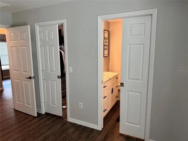 an entryway with wooden floor and cabinet