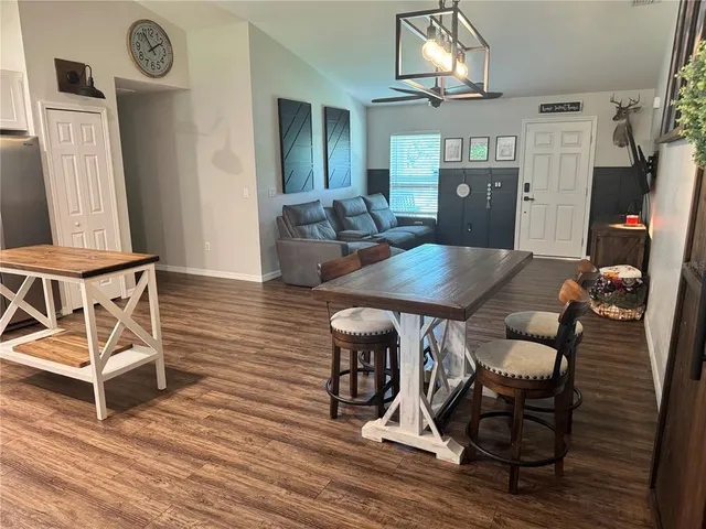 a view of a dining room with furniture and wooden floor