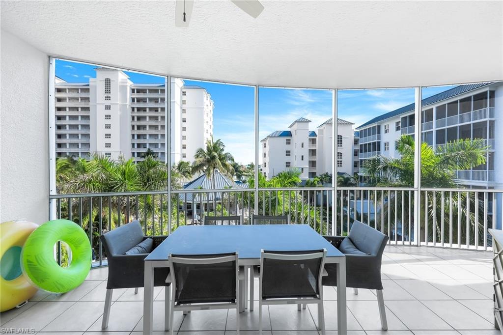 470 Launch Circle, Unit 403 Naples, FL 34108 - Photo 15 of 32 a view of a chairs and table in the balcony