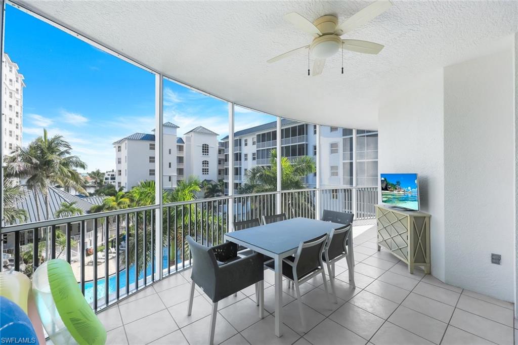 470 Launch Circle, Unit 403 Naples, FL 34108 - Photo 16 of 32 a view of a chairs and table in the balcony