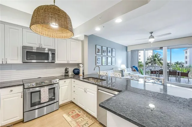 a kitchen with a stove a sink and a microwave