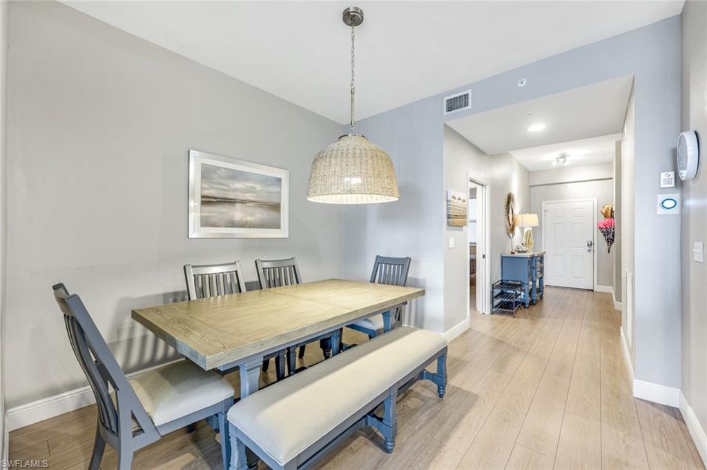470 Launch Circle, Unit 403 Naples, FL 34108 - Photo 6 of 25 a dining room with furniture and window