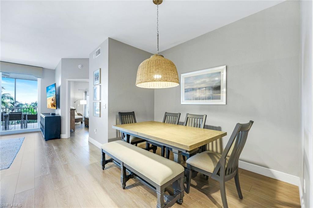 470 Launch Circle, Unit 403 Naples, FL 34108 - Photo 7 of 25 a dining room with furniture and window