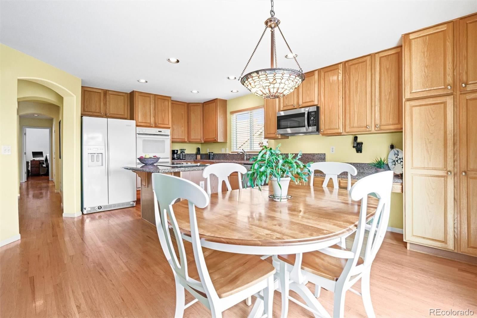 10230 Rustic Redwood Way Highlands Ranch, CO 80126 - Photo 13 of 50 a view of a dining room with furniture window and wooden floor