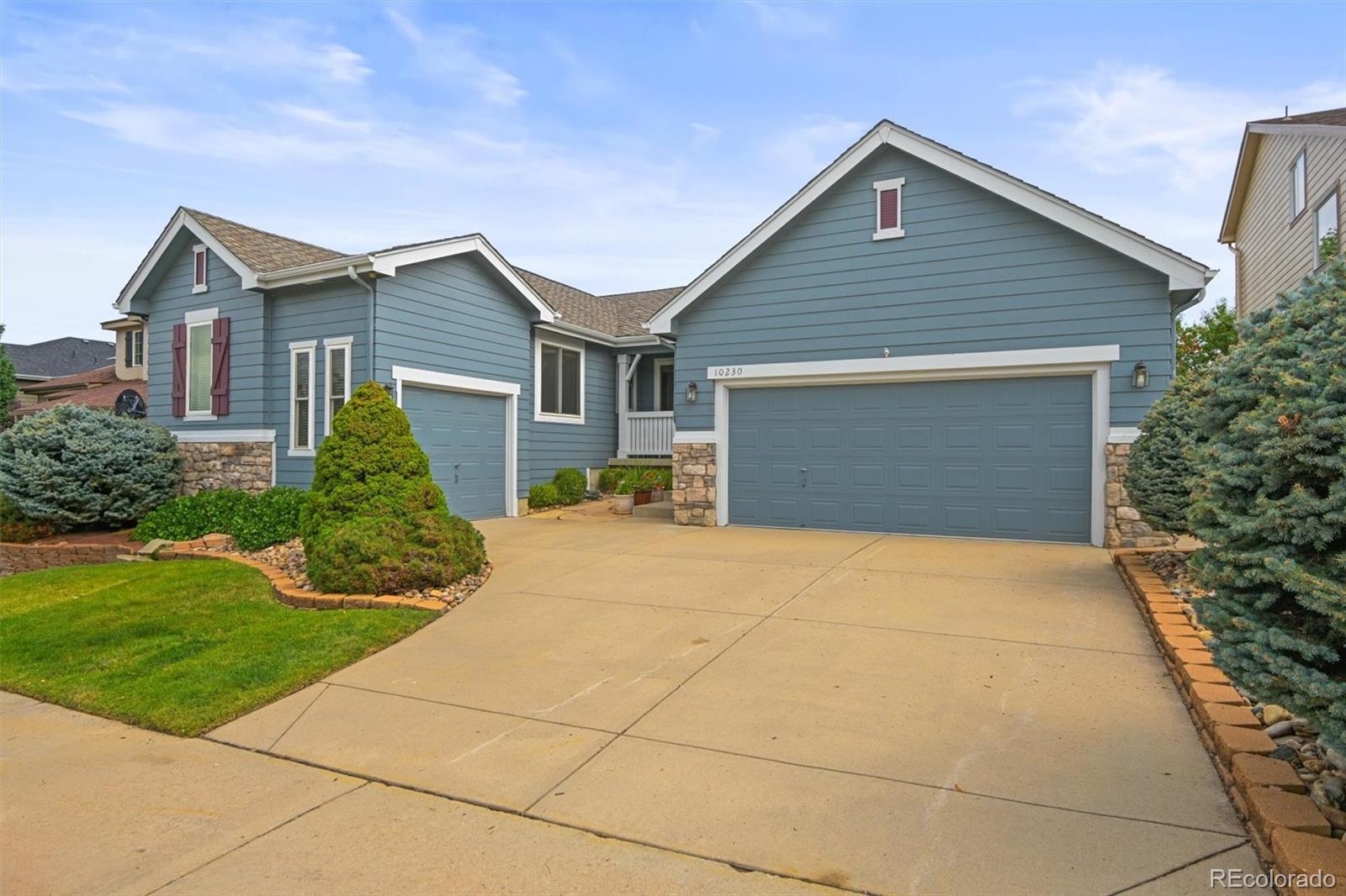 10230 Rustic Redwood Way Highlands Ranch, CO 80126 - Photo 2 of 50 a front view of house with yard and green space