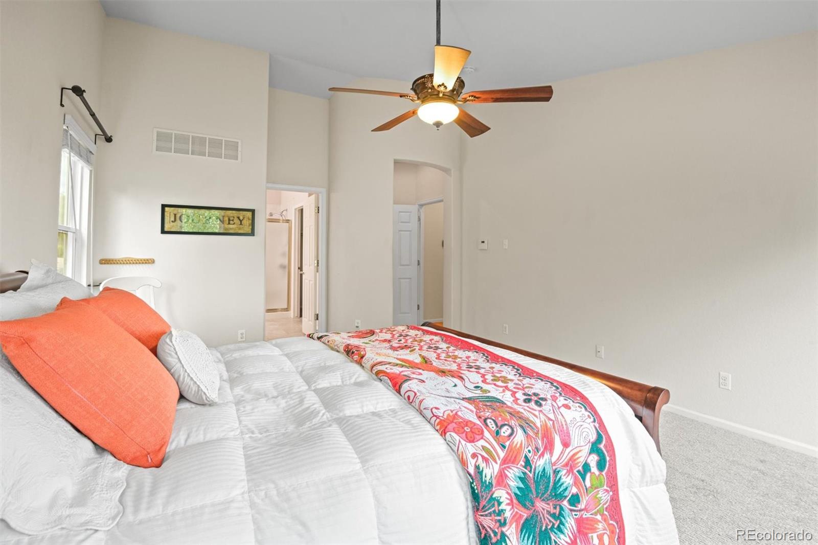 10230 Rustic Redwood Way Highlands Ranch, CO 80126 - Photo 23 of 50 a bedroom with a bed and a chandelier