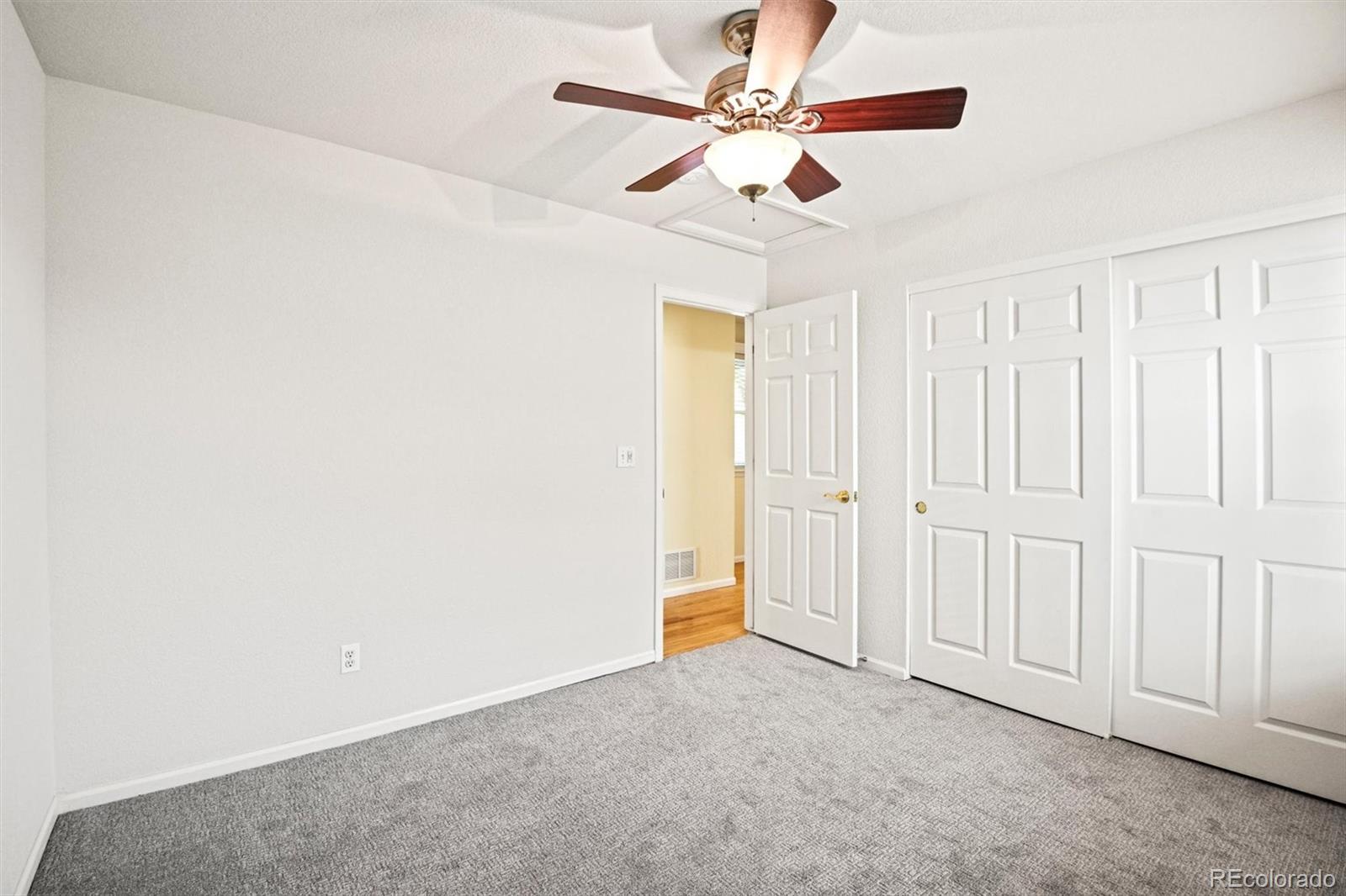 10230 Rustic Redwood Way Highlands Ranch, CO 80126 - Photo 26 of 50 an empty room with a ceiling fan