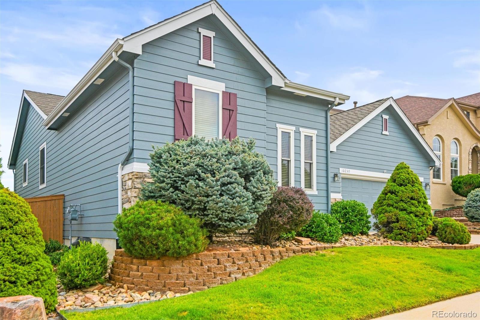 10230 Rustic Redwood Way Highlands Ranch, CO 80126 - Photo 3 of 50 a front view of a house with a yard