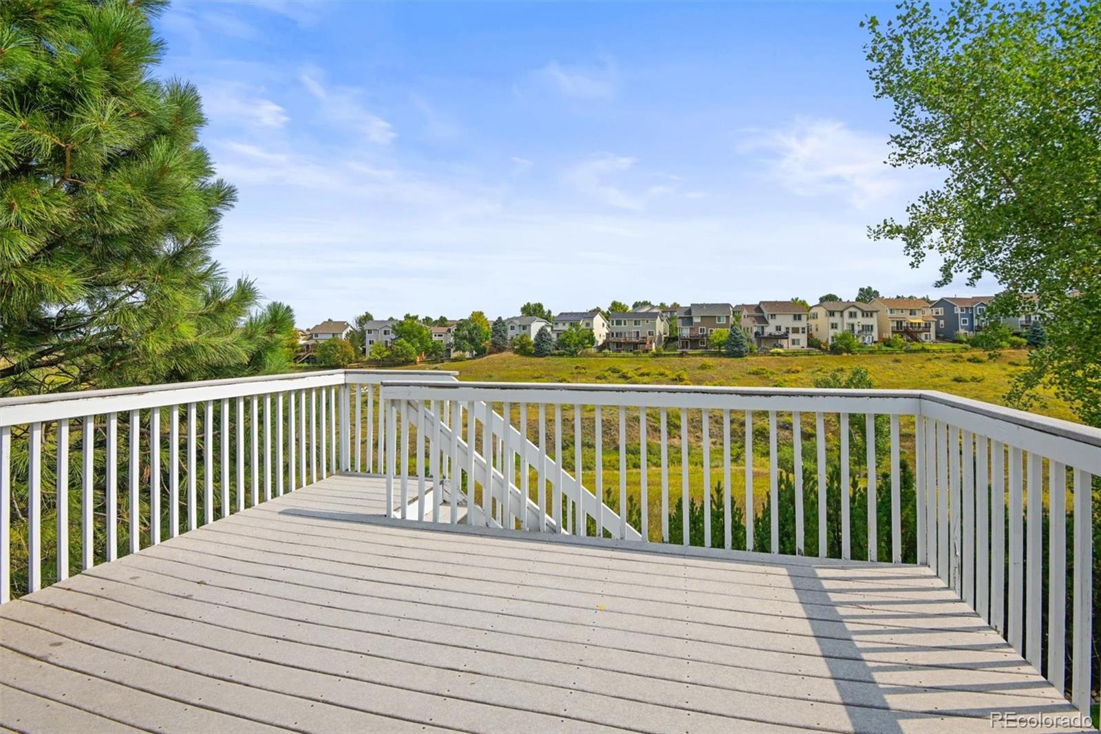 10230 Rustic Redwood Way Highlands Ranch, CO 80126 - Photo 39 of 50 a balcony with wooden floor and fence